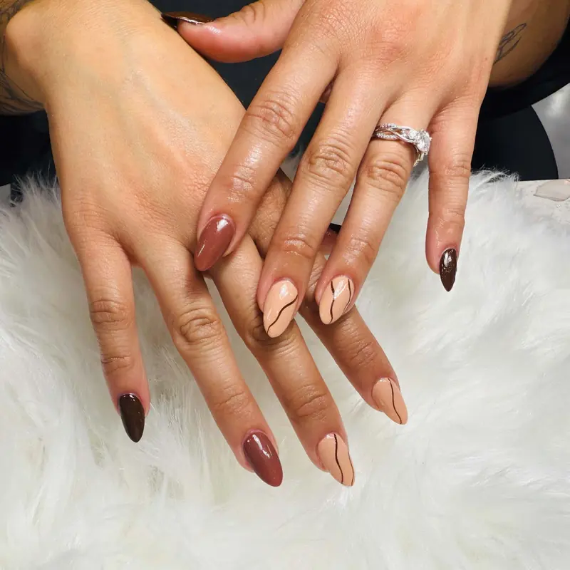 Chocolate brown and nude nails with swirl line art