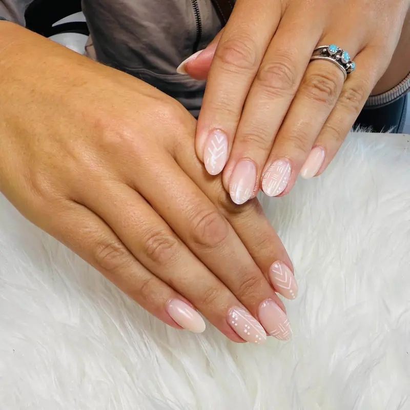 Soft nude nails with white lace detail