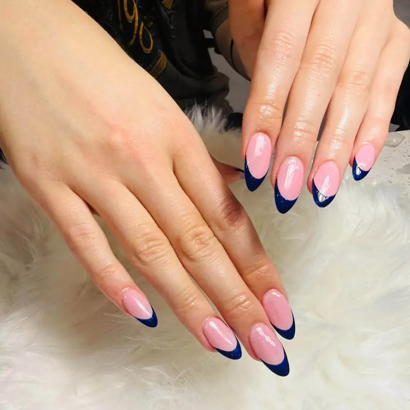 Almond nails with navy blue French tips